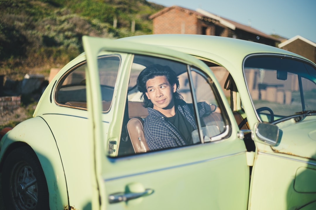 young people driving green car