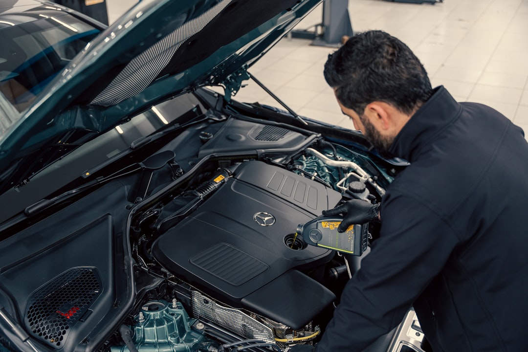 Mechanic inspecting a used car engine