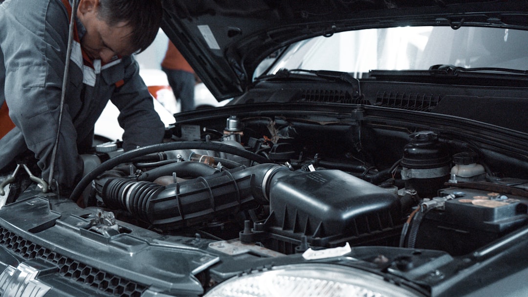 Mechanic inspecting a used car engine